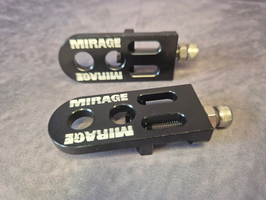 Two black metal chain tensioner components with 'Mirage' branding on a grey background
